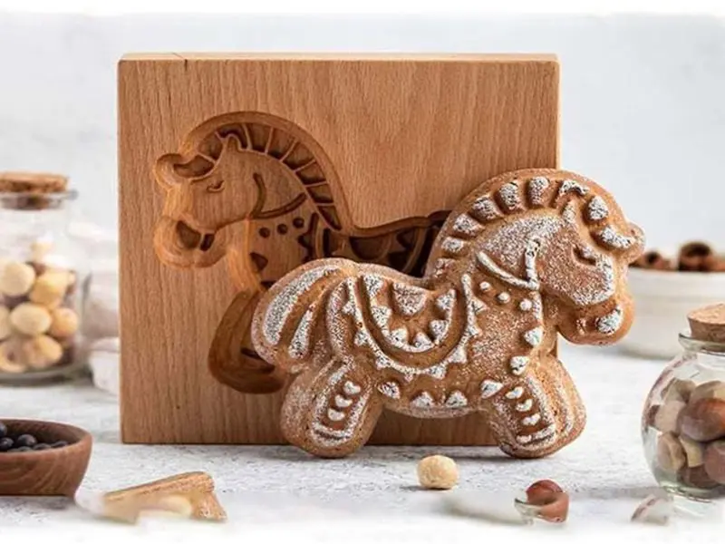 A beautiful 3D wooden sculpture emerging from the machine, demonstrating the CNC router's ability to create complex three-dimensional shapes