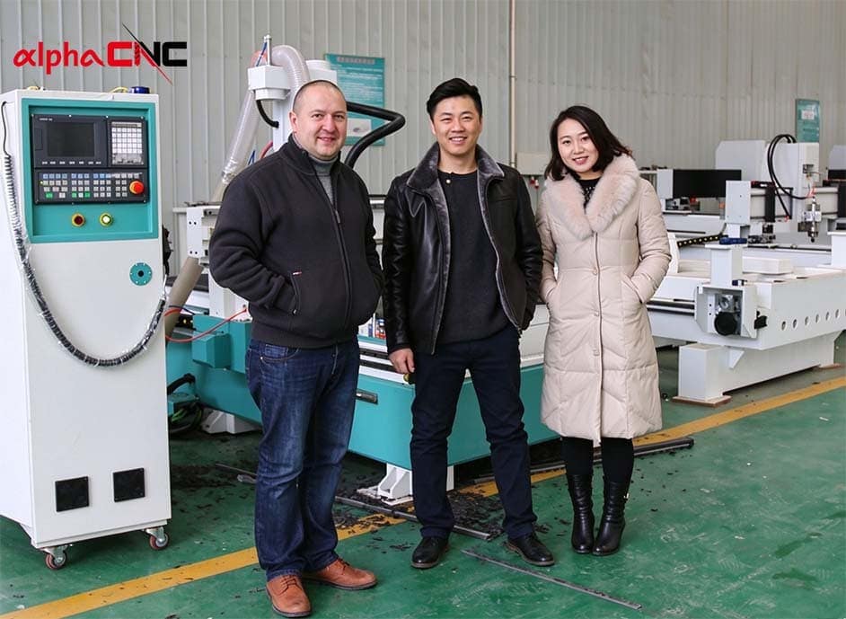A photo of the Alpha CNC team members with a client