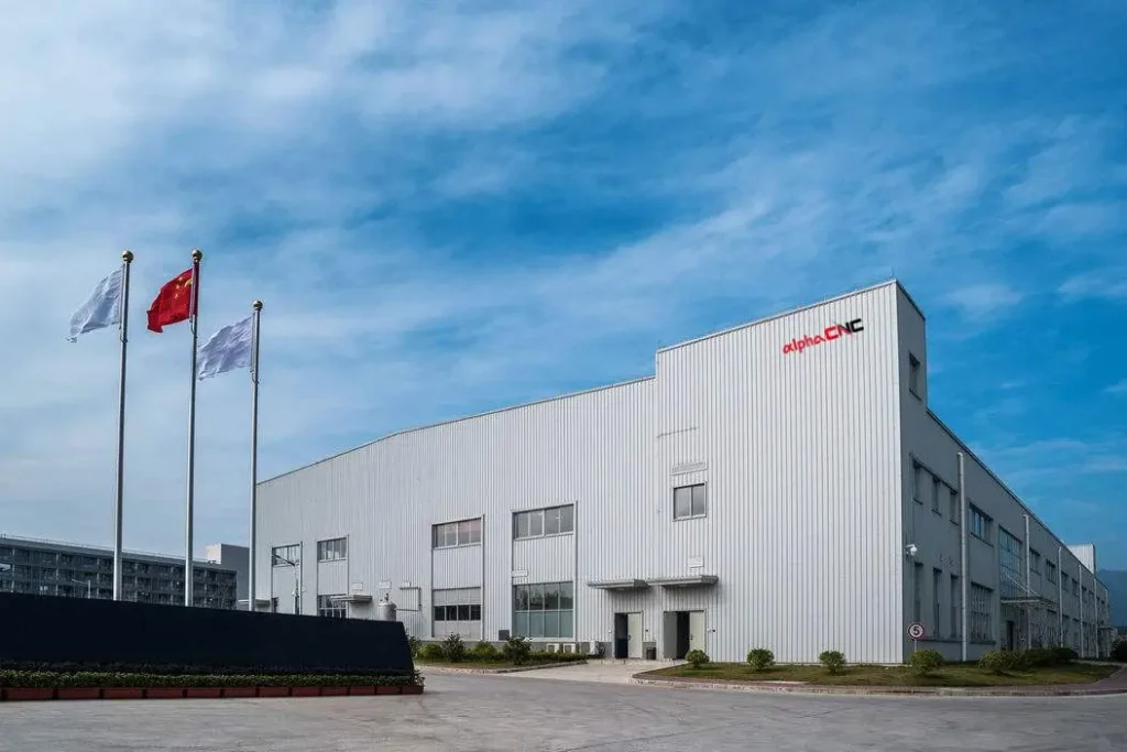 Alpha CNC team operating advanced CNC carving machines in our smart manufacturing facility, showcasing precision engineering for industrial applications