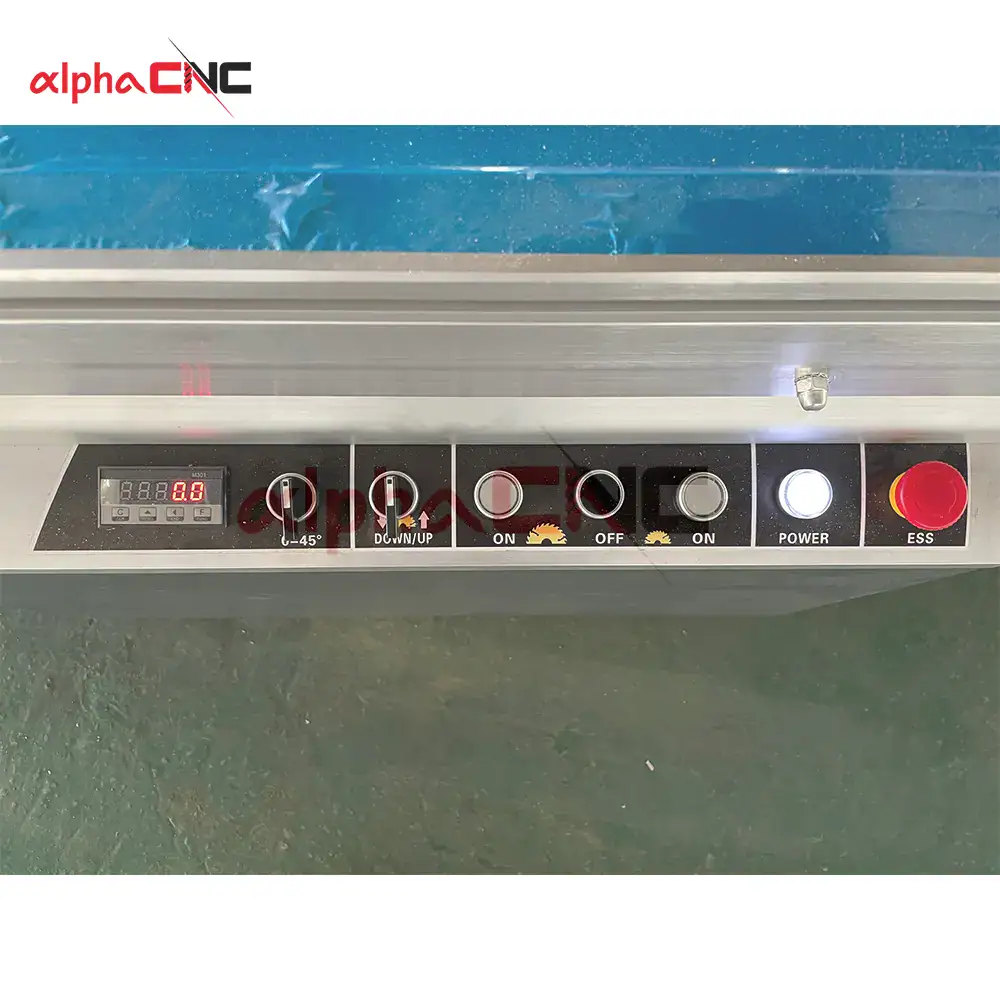 Close-up of the user-friendly CNC control interface and emergency stop safety switch on the sliding table saw.