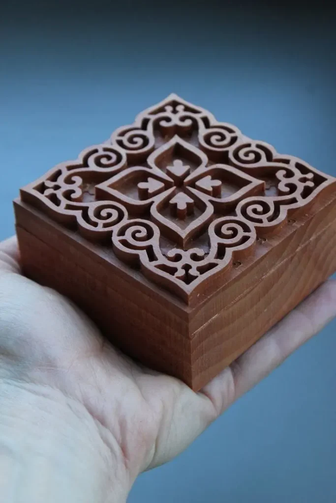 Custom wooden jewelry box with ornate, CNC-machined sides and dovetail joints