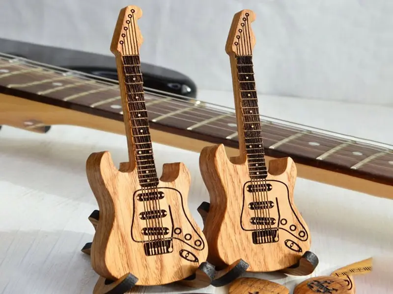 Intricate custom dragon engraving on an acoustic guitar top, machined with a precision CNC carving machine