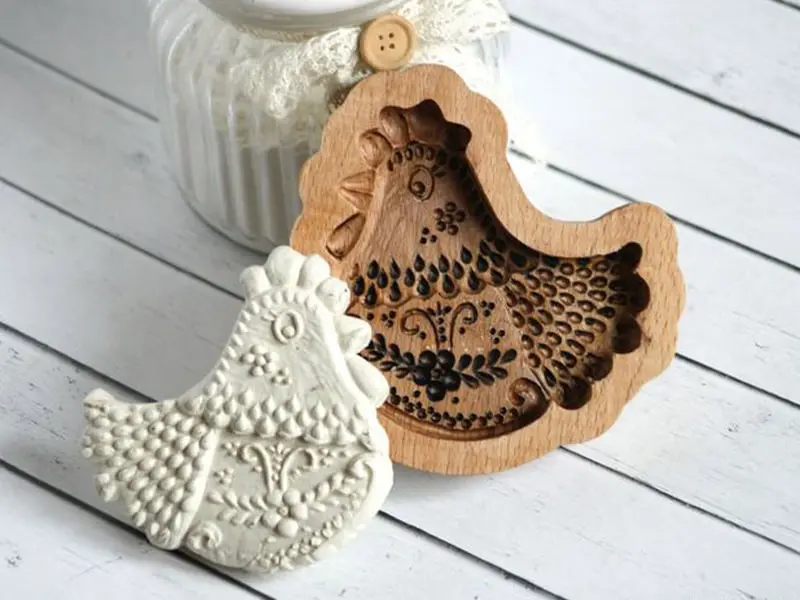 A series of identical, intricately carved wooden molds lined up after being batch-produced on a CNC router, ensuring consistency and efficiency