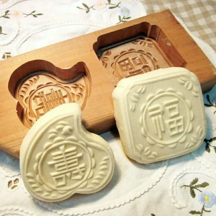 A large, robust stamping die mold being machined from a solid block of steel on a heavy-duty CNC router
