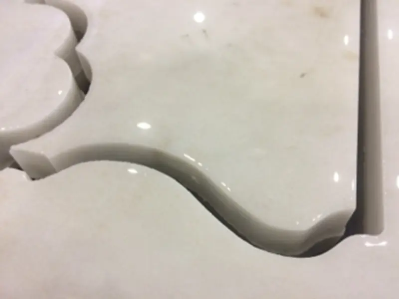 CNC router precisely engraving detailed patterns on marble