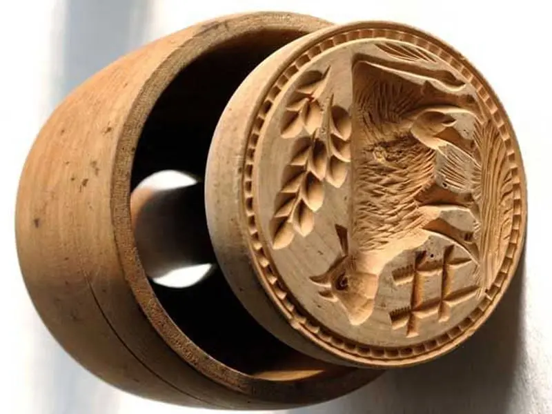 close-up shot of a CNC router bit creating an incredibly detailed and intricate geometric pattern in dark walnut wood