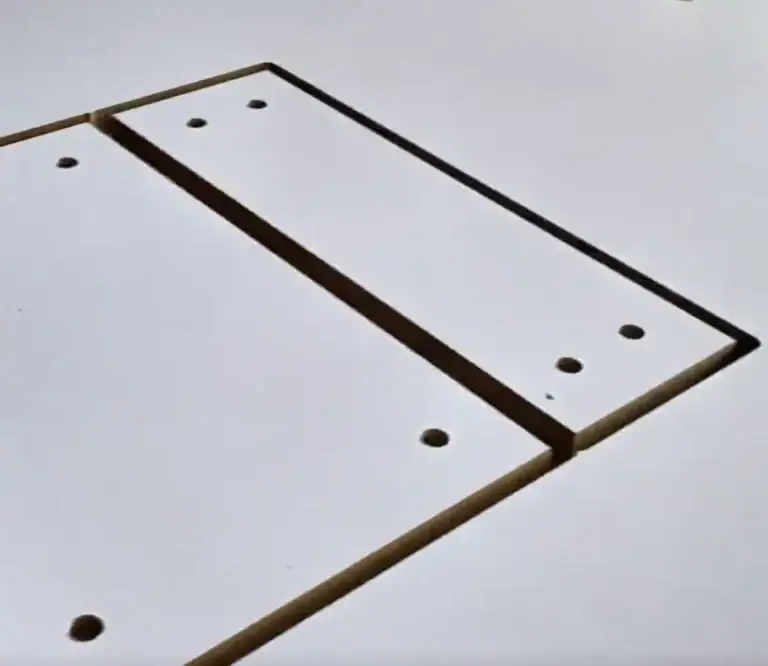 Close-up view of perfectly drilled holes in a wood workpiece, highlighting the accuracy of the APS-2030-DR's automatic drilling capability.