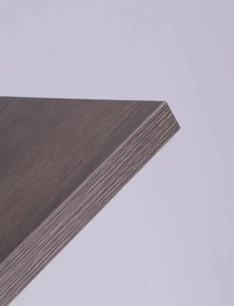 Sample of a contoured furniture panel with smooth, consistent edge banding adhering perfectly to the shape.