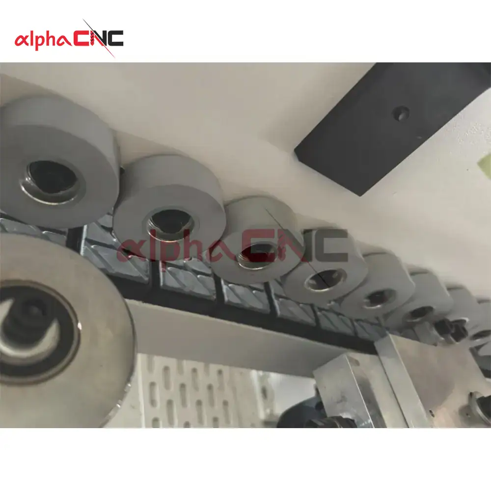 Detail of the heavy-duty pressure rollers ensuring even glue distribution and a strong, durable bond on the edge band.