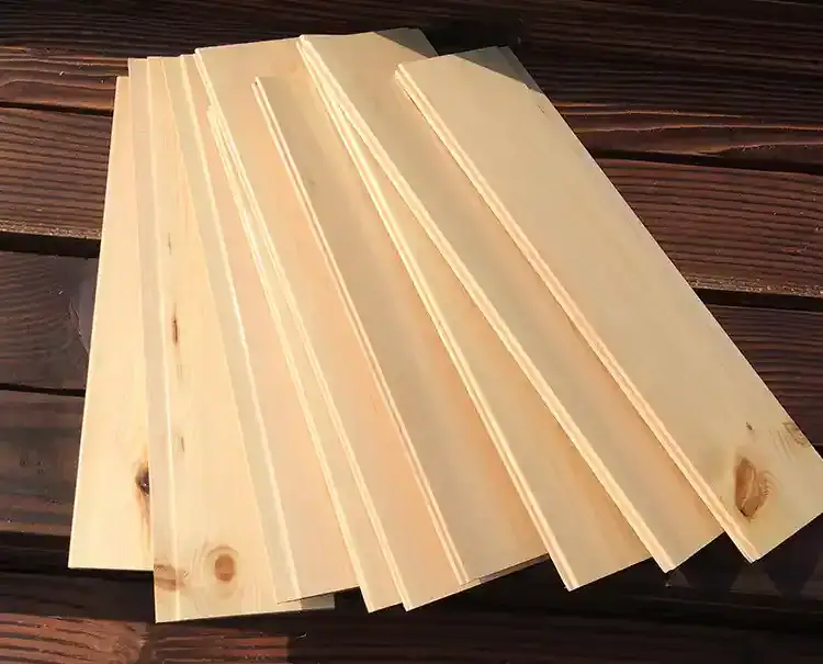 Multiple identical cabinet side panels cut to exact dimensions, showcasing the repeatability of the CNC sliding saw