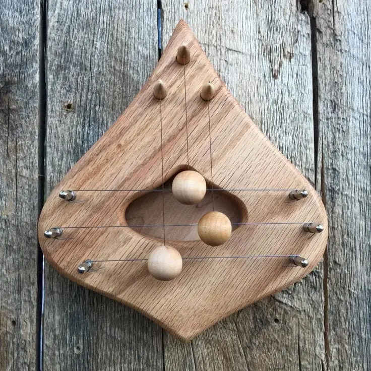Close-up of a finely carved scroll on a double bass pegbox, made possible by CNC technology