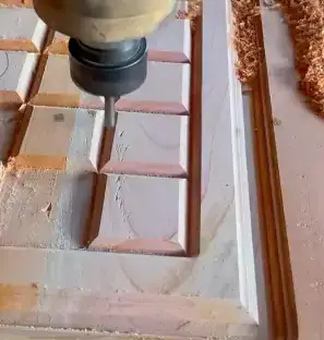 Close-up of a wood panel with detailed engraving and carving patterns, produced by the high-speed spindle of the APS-2030-DR